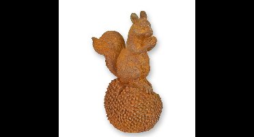 A RUSTY CAST IRON FIGURINE OF A SQUIRREL ON A CHESTNUT