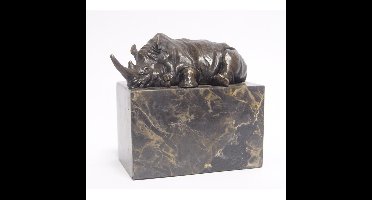 A BRONZE SCULPTURE OF A LYING RHINOCEROS