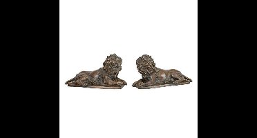 A BRONZE PAIR OF RECLINING LIONS